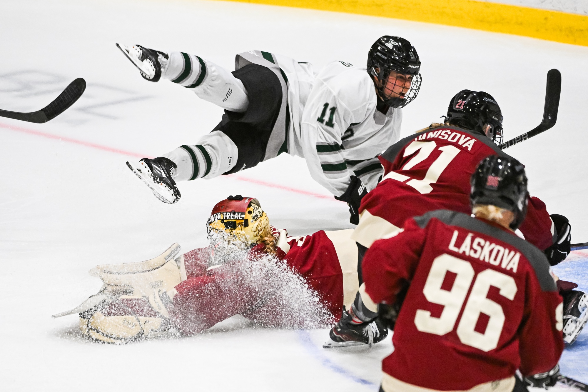 Jan 13, 2024; Montreal, Quebec, CANADA; Boston forward Alina Muller (11)flies in the air after a collision with Montreal goalie Ann-Renee Desbiens (35) during the second period in a PWHL ice hockey game at Verdun Auditorium. Mandatory Credit: David Kirouac-USA TODAY Sports