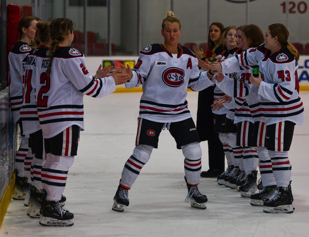 Emma Gentry greeted by her teammates.