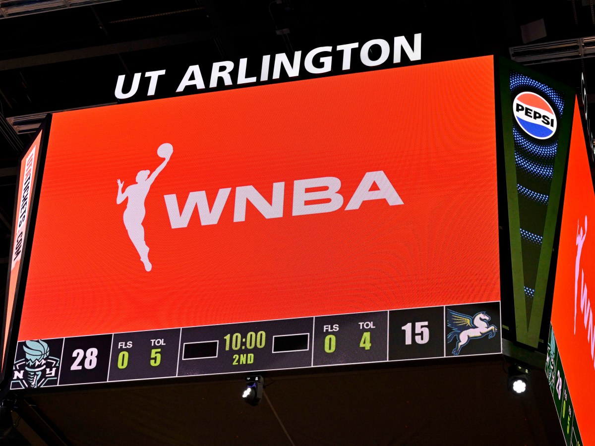 The jumbotron at College Park Center displays the WNBA logo in white against an orange background.